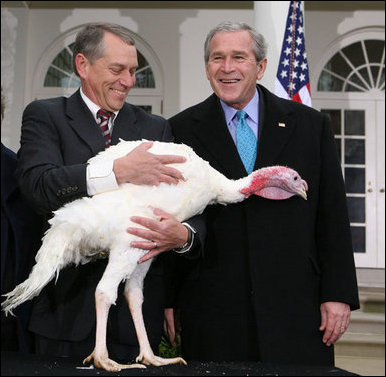President George W. Bush is joined by Lynn Nutt of Springfield, Mo., as he poses with 'Flyer' the turkey during a ceremony Wednesday, Nov. 22, 2006 in the White House Rose Garden, following the President’s pardoning of the turkey before the Thanksgiving holiday.