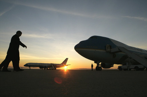President George W. Bush is greeted by a warm sunrise as he walks to Air Force One Monday, Nov. 27, 2006, en route to Tallinn, Estonia, where he will meet with the President Toomas Hendrik Ilves and Prime Minister Andrus Ansip. President Bush will then travel to Riga, Latvia, to participate in the NATO Summit. White House photo by Eric Draper