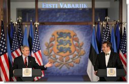 President George W. Bush smiles as he joins President Toomas Hendrik Ilves of Estonia, at the National Bank of Estonia in Tallinn Tuesday, Nov. 28, 2006, for a joint press availability. President Bush told his counterpart, "I'm proud to be the first sitting American President to visit Estonia."  White House photo by Paul Morse