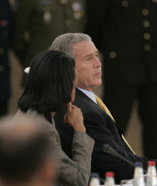 President George W. Bush confers with Secretary of State Condoleezza Rice Wednesday, Nov. 29, 2006, during the 2006 NATO Summit in Riga, Latvia. White House photo by Paul Morse
