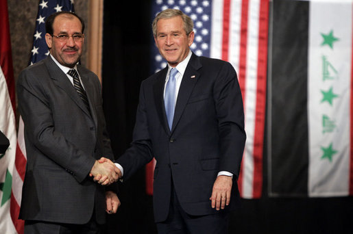 President George W. Bush and Prime Minister Nouri al-Maliki shake hands after a joint press availability Thursday, Nov. 30, 2006, in Amman, Jordan. The leaders later issued a joint statement in which they said they were, "Pleased to continue our consultations on building security and stability in Iraq." White House photo by Paul Morse