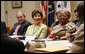 President George W. Bush and Laura Bush speak with their guests at a meeting on World AIDS Day in the Roosevelt Room at the White House, Friday, Dec. 1, 2006, who support the President’s Emergency Plan for AIDS Relief (PEPFAR), which is the largest international health initiative in history dedicated to a single disease. Angelina Magaga, Center Coordinator for the Light and Courage Center Trust in Botswana, Africa, is seen at right. White House photo by Eric Draper