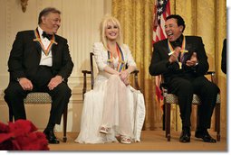 Conductor Zubin Mehta laughs with singers Dolly Parton and William "Smokey" Robinson during a reception for the Kennedy Center honorees in the East Room Sunday, Dec. 3, 2006.  White House photo by Eric Draper