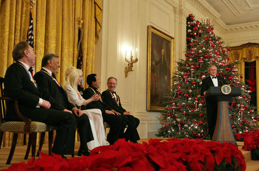 President George W. Bush speaks during a reception for the Kennedy Center honorees in the East Room Sunday, Dec. 3, 2006. They are, from left: musical theater composer Andrew Lloyd Webber; conductor Zubin Mehta; country singer Dolly Parton; singer and songwriter William "Smokey" Robinson; and film director Steven Spielberg. White House photo by Shealah Craighead