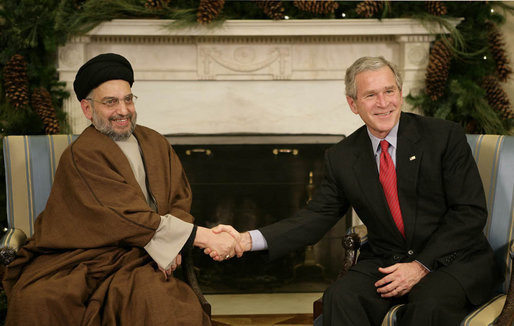 President George W. Bush welcomes Sayyed Abdul-Aziz Al-Hakim, Leader of the Supreme Council for the Islamic Revolution in Iraq, to the White House Monday, Dec. 4, 2006. Said the President, "I appreciate so very much His Eminence's commitment to a unity government. I assured him the United States supports his work and the work of the Prime Minister to unify the country." White House photo by Eric Draper