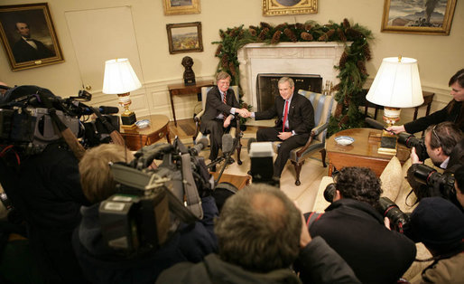 President George W. Bush exchanges handshakes with U.N. Ambassador John Bolton during his visit Monday, Dec. 4, 2006, to the White House. Earlier, upon announcement of the Ambassador's resignation, the President said in a statement, "It is with deep regret that I accept John Bolton's decision to end his service." White House photo by Eric Draper