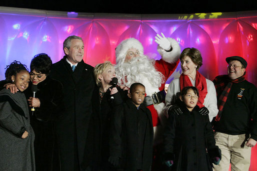 President George W. Bush and Laura Bush join entertainers Eartha Kitt, left, and Cathy Rigby, center, along with Santa Claus, invited children and The Singing Angels choir director Charles Eversole, right, on stage Thursday, Dec. 7, 2006, at the 2006 Christmas Pageant of Peace and the 83rd lighting of the National Christmas Tree on the Ellipse in Washington, D.C. White House photo by Kimberlee Hewitt