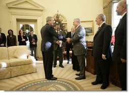 President George W. Bush shakes the hand of Vice President Tariq al-Hashemi of Iraq as they near the end of their Oval Office visit Tuesday, Dec. 12, 2006. The President told Vice President Hashemi, "Our objective is to help the Iraqi government deal with the extremists and killers, and support the vast majority of Iraqis who are reasonable people who want peace."  White House photo by Eric Draper