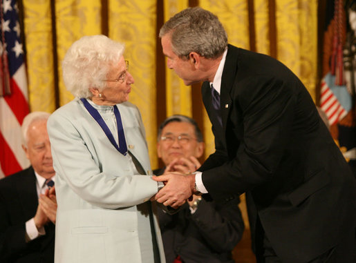 President George W. Bush congratulates Ruth Johnson Colvin after presenting her with the Presidential Medal of Freedom Friday, Dec. 15, 2006, in the East Room of the White House. Said the President, "Ruth Colvin is a person of intelligence and vision and heart. And she has earned the gratitude of many, and the admiration of us all." White House photo by Eric Draper