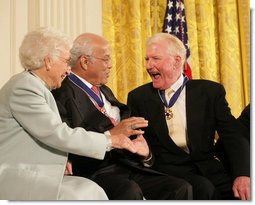 Author Paul Johnson is congratulated by Dr. Norman C. Francis and Ruth Johnson Colvin after receiving his Presidential Medal of Freedom from President George W. Bush Friday, Dec. 15, 2006, during ceremonies in the East Room of the White House. In honoring Mr. Johnson, President Bush said, "Our country honors Paul Johnson, and proudly calls him a friend."  White House photo by Shealah Craighead
