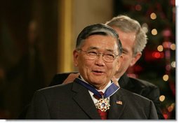 President George W. Bush presents the 2006 Presidential Medal of Freedom to former Secretary of Transportation Norman Mineta during ceremonies Friday, Dec. 15, 2006, in the East Room of the White House. Upon introduction, President Bush said, "Norman Mineta's whole life has been an extraordinary journey. he has given his country a lifetime of leadership, devotion to duty and personal character."  White House photo by Shealah Craighead