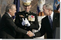 President George W. Bush and Secretary of Defense Donald Rumsfeld shake hands following President Bush's remarks honoring outgoing Secretary Rumsfeld during an Armed Forces Full Honor Review at the Pentagon Friday, Dec. 15, 2006, as Joint Chiefs of Staff Chairman General Peter Pace applauds.  White House photo by Paul Morse