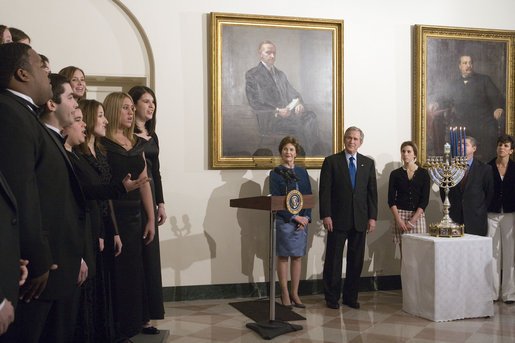 President George W. Bush and Laura Bush listen to Indiana University’s A Cappella Choir, HooShir, sing during the lighting of the Menorah during the annual White House Hanukkah reception Monday, Dec. 18, 2006. Pictured at right is Ariel Cohen, 14, and her parents Dan and Rachel Cohen. White House photo by Shealah Craighead