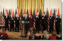 President George W. Bush is applauded as he addresses his remarks to invited guests prior to signing H.R. 5682 The United States-India Peaceful Atomic Cooperation Act, Monday, Dec. 18, 2006, in the East Room of the White House. Left to right are Rep. Thaddeus McCotter, R-Mich.; Rep.Gary Ackerman, D- NY; Sen. Richard Lugar, R-Ind.; Sen. Bill Frist, R-Tenn.; Secretary of State Condoleezza Rice; Rep. Joseph Crowley, D-NY; Sen. George Allen, R- Va.; Rep. Frank Pallone Jr., D-NJ; and Ambassador to the U.S. Raminder Jassal, Charge D’affaires of India.  White House photo by Eric Draper