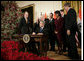 President George W. Bush is joined by U.S. Secretary of State Condoleezza Rice and U.S. legislators, as he signs H.R. 5682 The United States-India Peaceful Atomic Cooperation Act, Monday, Dec. 18, 2006, in the East Room of the White House. H.R. 5682 will allow the U.S. and India to share civilian nuclear technology and bring India’s civilian nuclear program under the safeguards of the International Atomic Energy Agency. White House photo by Eric Draper
