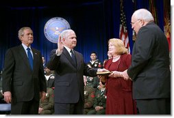 Vice President Dick Cheney swears in Robert Gates as Secretary of Defense at the Pentagon Monday, Dec. 18, 2006. Mr. Gate's wife Becky is pictured holding the Bible during the ceremony. White House photo by Eric Draper