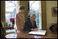 Laura Bush stands by President George W. Bush as he signs H.R. 6143, the Ryan White HIV/AIDS Treatment Modernization Act of 2006, in the Oval Office Tuesday, Dec. 19, 2006. White House photo by Eric Draper