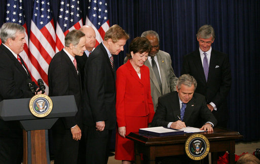 President George W. Bush signs H.R. 6407, the Postal Accountability and Enhancement Act, Wednesday, Dec. 20, 2006, at the Eisenhower Executive Office Building in Washington, D.C., joined by, from left to right, Postmaster General Jack Potter, Sen. Thomas Carper of Delaware, James C. Miller III, Chairman of the Postal Service Board of Governors; Rep. Tom Davis of Virginia, Sen. Susan Collins of Maine, Rep. Danny Davis of Illinois and Rep. John McHugh of New York. White House photo by Eric Draper