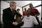 President George W. Bush shakes the hand of SSgt. Marcus Wilson after awarding him two Purple Hearts at the Walter Reed Army Medical Center in Washington, D.C., Friday, Dec. 22, 2006, as Mrs.Laura Bush and members of the Marine's family look on. Wilson, who is from Dermott, Arkansas, is recovering from wounds suffered in Operation Iraqi Freedom. White House photo by Eric Draper