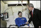 President George W. Bush congratulates U.S. Army Pvt. First Class Jace Badia of Tampa, after presenting him with a Purple Heart Friday, Dec. 22, 2006, during a visit to Walter Reed Army Medical Center where the soldier is recovering from injuries suffered in Operation Iraqi Freedom. White House photo by Eric Draper