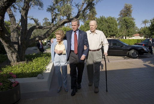 President George W. Bush walks with Former President Gerald Ford and Betty Ford after arriving for a visit in Rancho Mirage, California, Sunday, April 23, 2006. White House photo by Eric Draper