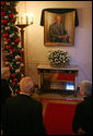 Visitors to the White House look at the portrait of former President Gerald R. Ford is draped with a black cloth in the Cross Hall of the White House Wednesday, Dec. 27, 2006. President Ford passed away Tuesday evening, Dec. 26. The portrait was painted by artist Everett Raymond Kinstler in 1977. 
