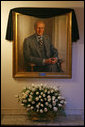 The portrait of former President Gerald R. Ford is draped with a black cloth in the Cross Hall of the White House Wednesday, Dec. 27, 2006. President Ford passed away Tuesday evening, Dec. 26. The portrait was painted by artist Everett Raymond Kinstler in 1977. 