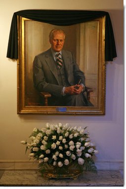 The portrait of former President Gerald R. Ford is draped with a black cloth in the Cross Hall of the White House Wednesday, Dec. 27, 2006. President Ford passed away Tuesday evening, Dec. 26. The portrait was painted by artist Everett Raymond Kinstler in 1977.  