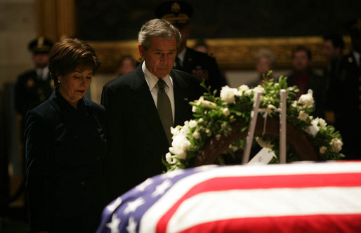 President George W. Bush and Mrs. Laura Bush stand next to the catafalque holding the flag-draped casket of former President Gerald R. Ford Monday, Jan. 1, 2007, in the Rotunda of the U.S. Capitol as they pay their final respects to the 38th President of the United States. White House photo by Eric Draper