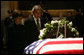 President George W. Bush and Mrs. Laura Bush stand next to the catafalque holding the flag-draped casket of former President Gerald R. Ford Monday, Jan. 1, 2007, in the Rotunda of the U.S. Capitol as they pay their final respects to the 38th President of the United States. White House photo by Eric Draper