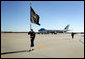 A Naval honor guard carries the Presidential Colors on the tarmac of Andrews Air Force Base, Md., as the plane carrying the body of former President Gerald R. Ford prepares to depart for Grand Rapids, Mich., Tuesday, January 2, 2007, following the former president's State Funeral in Washington, D.C. White House photo by David Bohrer