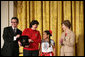 Mrs. Laura Bush presents Alicia Guadalupe Montero Perez, left, and Ingrid Janet Noh Canto, center, of La Chacara Children's Cultural Center a Coming Up Taller Award during a ceremony in the East Room Monday, Jan. 22, 2007. Gilberto Palmerin of the US-Mexico Foundation for Culture is pictured at the far left. Each year, the Coming Up Taller Awards recognize and reward excellence in community arts and humanities programs for underserved children and youth. White House photo by Shealah Craighead