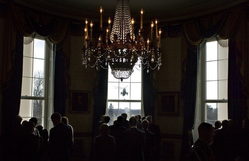 Guests attending the presentation of the Hugh S. Sidey Scholarship in print journalism watch as President George W. Bush arrives aboard Marine One from the Blue Room Friday, Jan. 26, 2007. White House photo by Shealah Craighead