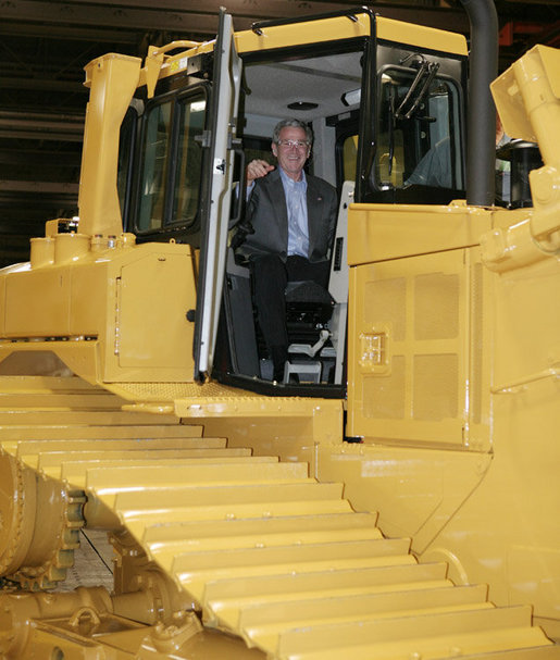 President George W. Bush inspects the driver’s compartment of a large Caterpillar bulldozer during a tour of the Caterpillar Inc. facility Tuesday, Jan. 30, 2007, in East Peoria, Ill., where President Bush addressed workers at the plant about the strength and growth of the U.S. economy. White House photo by Paul Morse