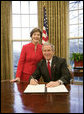 President George W. Bush is joined by Mrs. Laura Bush in the Oval Office at the White House, Thursday, Feb. 1, 2007, as President Bush prepares to sign the Presidential Proclamation in honor of American Heart Month. American Heart Month encourages Americans to take actions that reduce their risk and increase awareness of heart disease. White House photo by Eric Draper