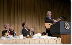 President George W. Bush and Representative Emanuel Cleaver, D-Mo., listen to Dr. Francis Collins during the National Prayer Breakfast in Washington, D.C., Thursday, Feb. 1, 2007. Dr. Collins is the director of the National Human Genome Research Institute.  White House photo by Eric Draper