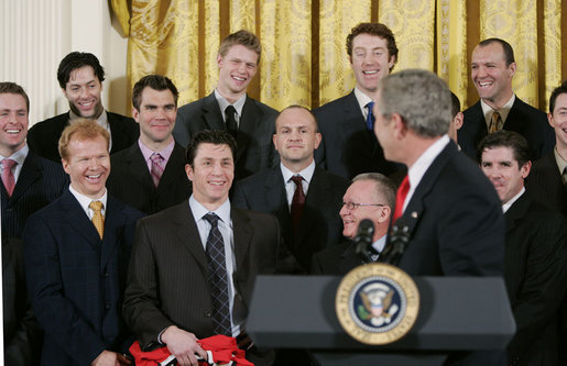 President George W. Bush jokes with members of the Carolina Hurricanes hockey team, winners of the 2006 Stanley Cup, Friday, Feb. 2, 2007 in the East Room at the White House. White House photo by Paul Morse