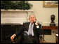 President George W. Bush laughs Monday morning, Feb. 5, 2007, during a phone call from the Oval Office to Jim Irsay, owner of the Super Bowl XLI champion Indianapolis Colts. White House photo by Eric Draper