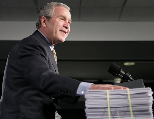 President George W. Bush places his hand on a large stack of legislative earmarks as he addresses the employees at Micron Technology Virginia in Manassas, Va., Tuesday, Feb. 6, 2007, on the economy and fiscal responsibility. President Bush voiced his concern about earmarks being slipped into spending bills saying, “If Congress is genuinely concerned about spending your money wisely, and I believe most members are, then, they must do something about earmarks.” White House photo by Paul Morse