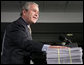 President George W. Bush places his hand on a large stack of legislative earmarks as he addresses the employees at Micron Technology Virginia in Manassas, Va., Tuesday, Feb. 6, 2007, on the economy and fiscal responsibility. President Bush voiced his concern about earmarks being slipped into spending bills saying, “If Congress is genuinely concerned about spending your money wisely, and I believe most members are, then, they must do something about earmarks.” White House photo by Paul Morse