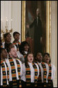 Members of the Jackson High School Black History Tour Group of Jackson, Mich., stand before a painting of George Washington in the East Room of the White House, Monday, Feb. 12, 2007, as they sing during the celebration of African American History Month. White House photo by Paul Morse