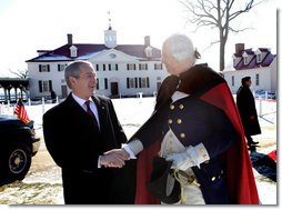 President George W. Bush shakes hands with General George Washington, played by actor Dean Malissa, following President Bush’s address at the Mount Vernon Estate, Monday, Feb. 19, 2007 in Mount Vernon, Va., honoring Washington’s 275th birthday. White House photo by Eric Draper