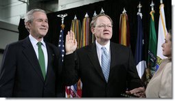 President George W. Bush attends the ceremonial swearing-in of Director of National Intelligence J. Michael “Mike” McConnell, Tuesday, Feb. 20, 2007 at Bolling Air Force Base in Washington, D.C., taking his oath of office as McConnell’s wife, Terry, holds the Bible.  White House photo by Paul Morse