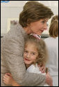 Mrs. Laura Bush receives a farewell hug from a young child at a Boys & Girls Club program Thursday, Feb. 22, 2007 at the D’Iberville Elementary School in D’Iberville, Miss. White House photo by Shealah Craighead