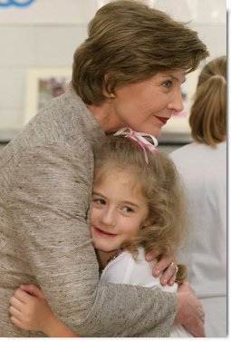 Mrs. Laura Bush receives a farewell hug from a young child at a Boys & Girls Club program Thursday, Feb. 22, 2007 at the D’Iberville Elementary School in D’Iberville, Miss. White House photo by Shealah Craighead
