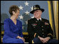 U.S. Army Major Bruce P. Crandall sits with his wife, Arlene, before a banner of the Medal of Honor in the East Room of the White House, Monday, Feb. 26, 2007, prior to Crandall being awarded the Medal of Honor for his extraordinary heroism as a 1st Cavalry helicopter flight commander in the Republic of Vietnam in November 1965. White House photo by Eric Draper
