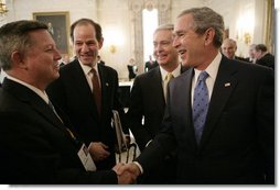 President George W. Bush shakes hands with Nebraska Governor Dave Heineman, left, joined by New York Governor Eliot Spitzer, center and Gov. Mike Easley of North Carolina, following a meeting with the National Governors Association in the State Dining Room of the White House, Monday, Feb. 26, 2007. White House photo by Eric Draper