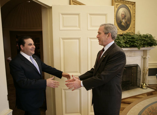 President George W. Bush reaches out to welcome President Elias Antonio Saca of El Salvador to the Oval Office Tuesday, Feb. 27, 2007. The leaders met for nearly an hour and discussed a number of topics, including an upcoming trade agreement between their countries, biofuels and the Millennium Challenge Account. White House photo by Eric Draper