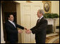President George W. Bush reaches out to welcome President Elias Antonio Saca of El Salvador to the Oval Office Tuesday, Feb. 27, 2007. The leaders met for nearly an hour and discussed a number of topics, including an upcoming trade agreement between their countries, biofuels and the Millennium Challenge Account. White House photo by Eric Draper