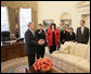 President George W. Bush offers a tour of the Oval Office to the leaders of military service organizations Wednesday, Feb. 28, 2007, following a meeting with the group to thank them for their dedication and commitment in support of America's military and their families at home. White House photo by Eric Draper